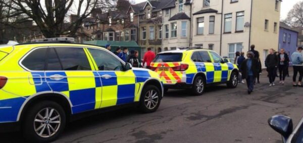 Two police cars parked in a street